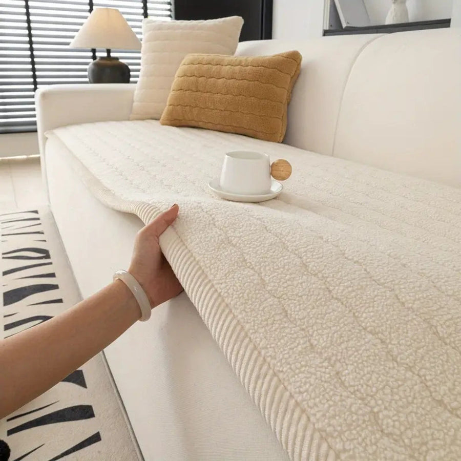 Thick plush microfiber sofa cover in Cream Cloud ivory draped over a modern sofa in a bright living room
