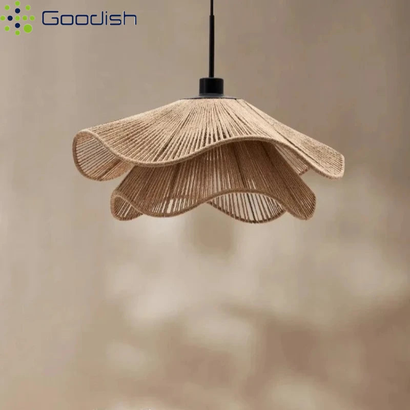 Hand-woven rattan flower pendant light with warm natural tone hanging in a minimalist room setting