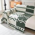 Green bohemian chenille couch cover styled on a loveseat with textured cushions and natural decor