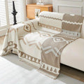 Bohemian chenille throw in black draped casually over an armchair beside a rattan side table