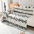 Bohemian reversible chenille couch cover draped over a modern sofa in a warm-toned living room