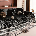 Full view of the Midnight Fern chenille cover neatly tucked over a sectional sofa in a modern earthy living room