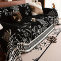 Woodland Charm chenille sofa cover styled on a loveseat with neutral linen throw pillows and rattan accents