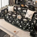 Full-length view of chenille sofa protector with knotted tassel edging styled on a three-seat sofa
