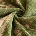 Overhead flat-lay showing the textured botanical weave and dense velvety pile of the chenille fabric