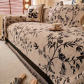 Styled overhead shot of chenille sofa throw in olive green layered with textured cushions and warm-toned home accessories