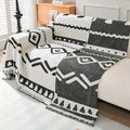 Bohemian reversible couch cover used as a lightweight bedspread on a linen-dressed bed