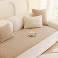 Detail shot of non-slip textured backing on the plush microfiber sofa cover showing grip layer