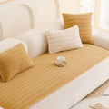 Cream Cloud sofa cover draped casually over a linen armchair beside a woven basket and potted plant