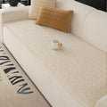 Side angle of thick plush sofa cover in Cream Cloud showing generous drape and plush pile catching natural light