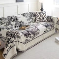 Muted lavender chenille sofa cover with rich textured floral weave layered on a cream-toned sectional