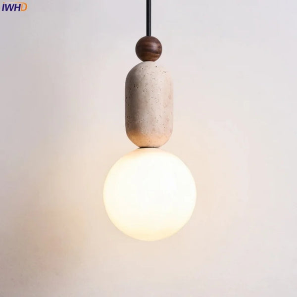 Detail shot of the natural travertine veining patterns on the pendant light body in warm daylight