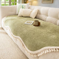 Detail shot of decorative tassel fringe edging on the woven chenille sofa cover in cream