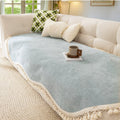 Full view of the reversible chenille sofa throw in olive charm draped casually across a couch arm