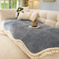 Overhead angle of the cream elegance chenille sofa cover showing the woven texture pattern and tassel border