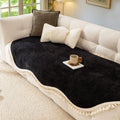 Olive charm chenille sofa cover folded neatly on a sofa seat highlighting the lightweight non-slip fabric