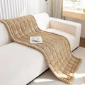 Close-up of hand-pleated edge detail on Cloud Texture colorway against a linen sofa arm