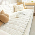 Snow Drift plush sofa cover styled on a light-toned couch with neutral throw pillows in a bright living room