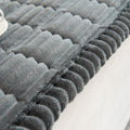 Plush sofa cover in Charcoal Calm folded neatly to display fabric weight and thickness