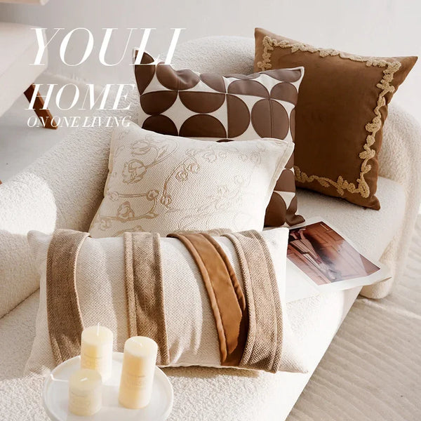 Brown French stamp decorative throw pillow cover displayed on a neutral linen sofa in a warm-toned living room