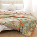 Detail of the cream and orange color palette of the boho throw against warm-toned decor